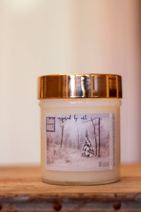 "Winter Wonderland" label on a 10oz Soy Candle with a wooden wick and a metallic lid. Choose your scent