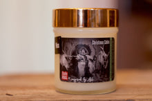 Load image into Gallery viewer, &quot;King Santa&quot; art by Shanna Koltz on a Soy candle with crackling wooden wick in a 10oz Glass Jar with a shiny lid