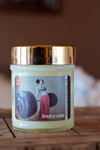 "Strength of a Woman," art by Shanna Koltz on a Soy candle with crackling wooden wick in a 10oz Glass Jar with a shiny lid