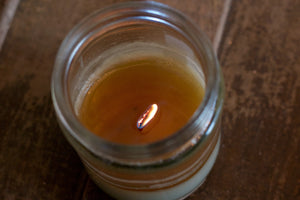 "Happy," art by Shanna Koltz on a Soy candle with crackling wooden wick in a 10oz Glass Jar with a shiny lid