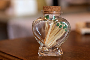 Matches in decorative glass heart jar